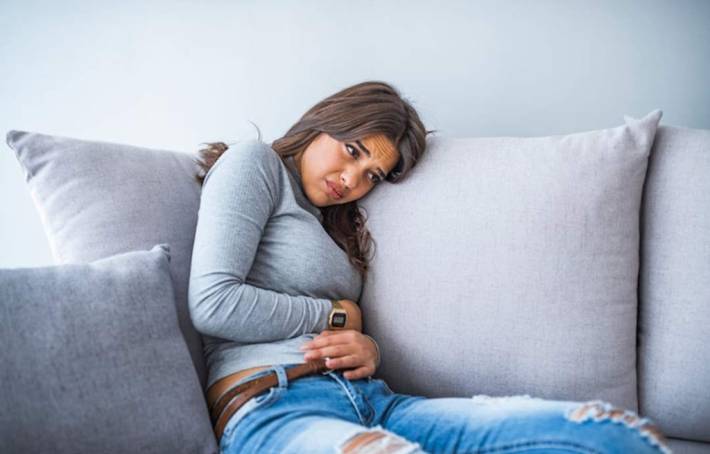 Woman experiencing digestive problems and abdominal discomfort